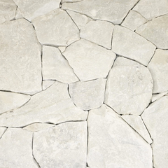 A close-up view of Mirella White Stone Cladding, featuring irregularly shaped, light-colored slabs with rough textures and uneven edges for a modern stone feature wall.