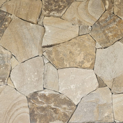 Close-up of Orana Stone Cladding, featuring irregularly shaped light brown and beige sandstone pieces with visible edges and split surface textures, arranged in a freestyle wall pattern.