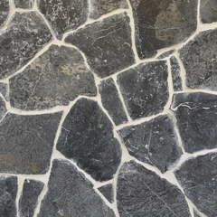 A close-up of Celestia Stone Cladding shows large, dark gray stones with white mortar in between. The free style design uses stones of different shapes and sizes, creating an uneven, textured granite wall surface.