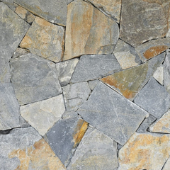 A close-up of Verona Stone Cladding reveals irregular gray and brown rocks with hand-split surfaces, showcasing varied textures and natural color, ideal for free style walling.