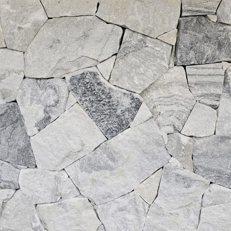 Luna Grey Stone Cladding features irregular, light gray and white quartzite tiles with darker streaks, fitted in a freestyle pattern for a textured, organic stone wall look. — Stone Cladding
