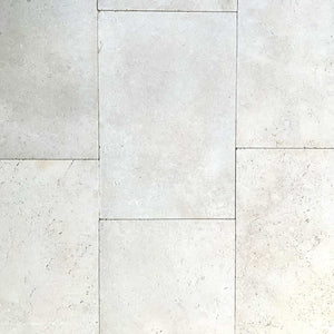 Close-up view of beige Galala Pearl Limestone Pavers arranged in a staggered pattern, highlighting natural texture and slight color variations—ideal for elegant wall cladding or pool paving.