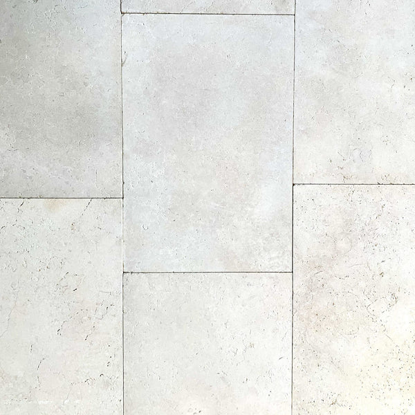 Close-up view of beige Galala Pearl Limestone Pavers arranged in a staggered pattern, highlighting natural texture and slight color variations—ideal for elegant wall cladding or pool paving.