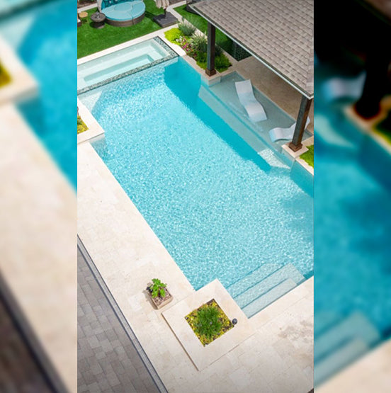 A pool with Galala Pearl Limestone Pavers, a deck, and a gazebo. — Natural Stone Paving