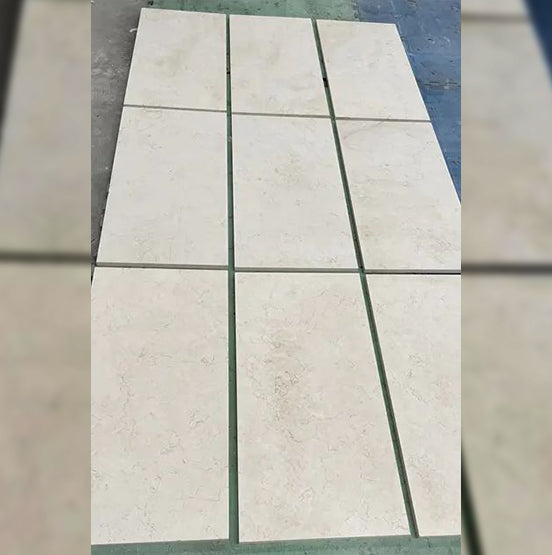 Nine rectangular Luxor Cream Limestone Pavers are arranged in a 3x3 grid with visible grout lines. The beige pavers have a subtle marbled texture, making them perfect for both indoor and outdoor applications. — Natural Stone Paving